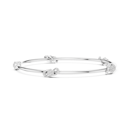 Minimalist floral crystal bangle bracelet featuring delicate flower-inspired charms on a sleek polished silver-tone bangle by Orova Jewels.