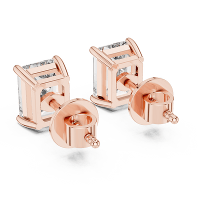 Emerald cut solitaire diamond stud earrings featuring rectangular-cut stones in a classic four-prong setting with secure screw-back closure by Orova Jewels.