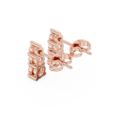 Three stone diamond drop stud earrings featuring brilliant round-cut stones in a vertical design with secure butterfly backs by Orova Jewels.