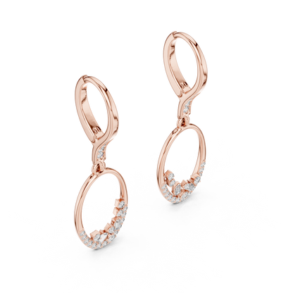 Oval diamond drop hoop earrings featuring an open oval frame with sparkling round and baguette-cut stone accents by Orova Jewels.