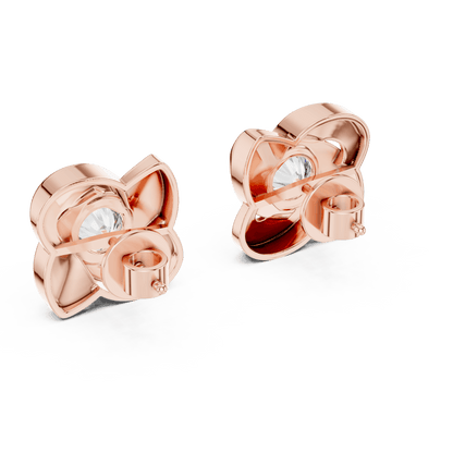 Twisted ribbon diamond stud earrings featuring a brilliant round center stone with a modern swirl design by Orova Jewels.