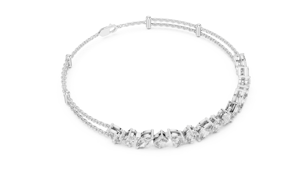 Marquise and emerald diamond tennis bracelet featuring mixed-cut sparkling stones in an elegant chain design by Orova Jewels.