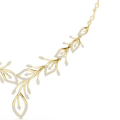 Nature-inspired yellow gold leaf necklace with an elegant vine design and sparkling stone accents by Orova Jewels.