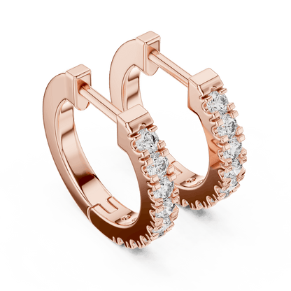 Diamond huggie hoop earrings featuring a row of sparkling round stones with a secure hinged closure by Orova Jewels.